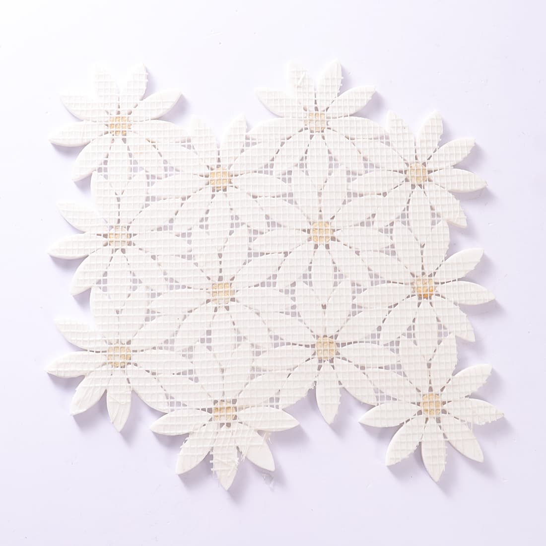 Back view of a white daisy mosaic tile sheet showing the mesh backing