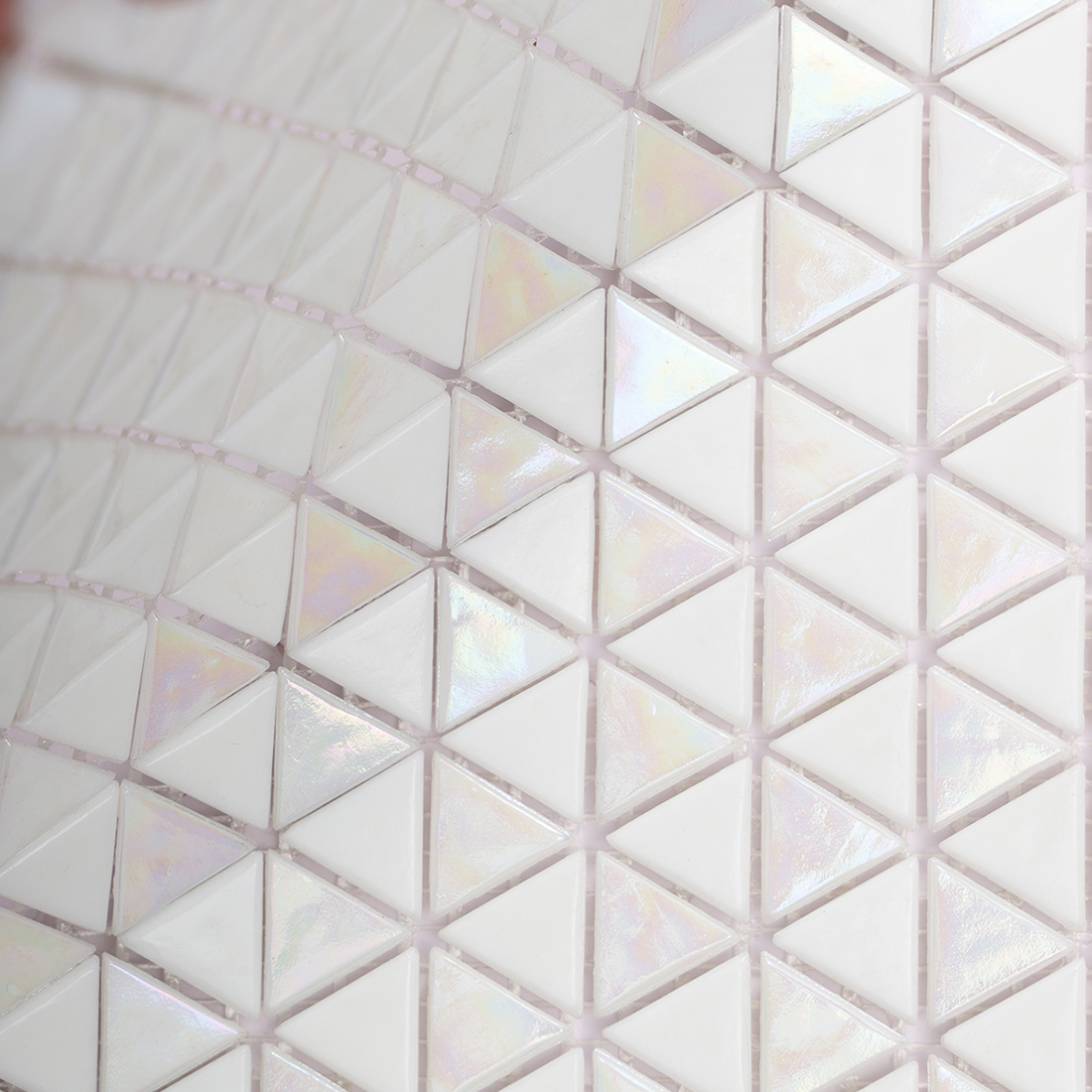 Angled close up of glossy white triangle glass mosaic tiles