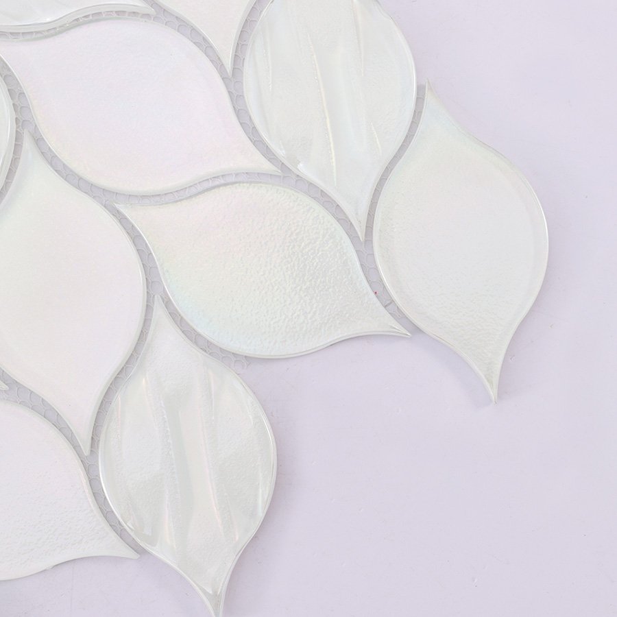 Close-up of white glass iridescent leaf mosaic tile with shimmering finish.