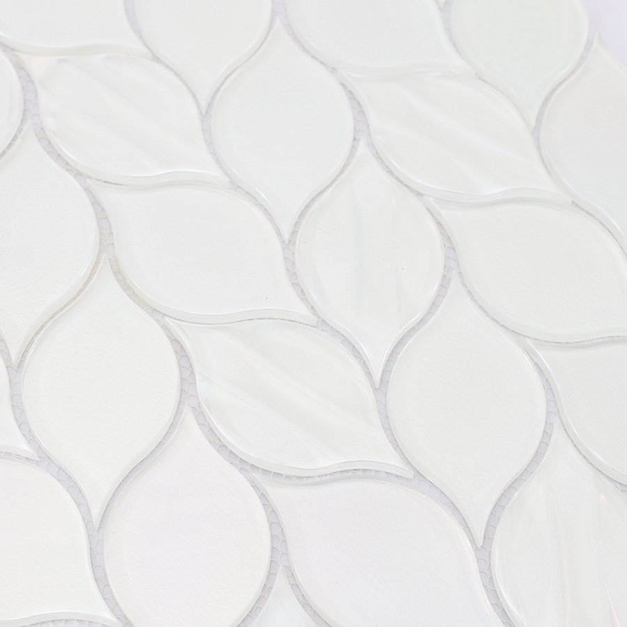 Textured surface detail of white glass iridescent leaf mosaic tile.