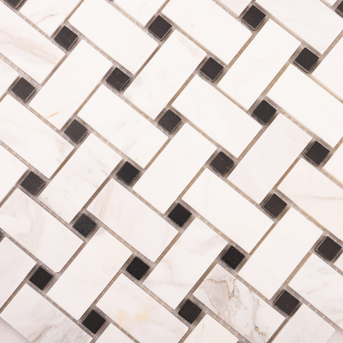 Surface view of white marble basket weave mosaic with natural stone variation.
