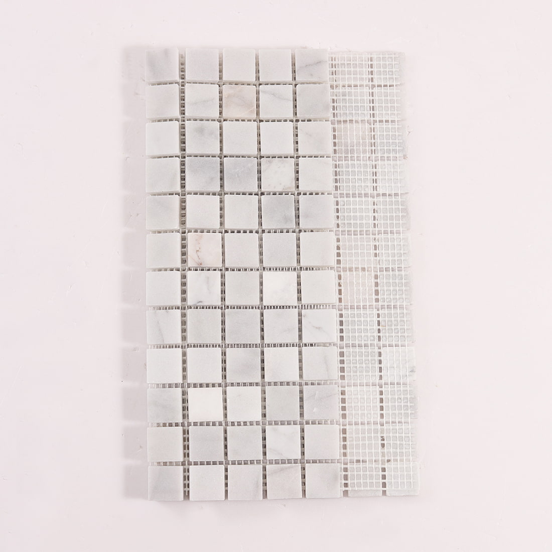 Back view of white marble square mosaic tiles with mesh backing