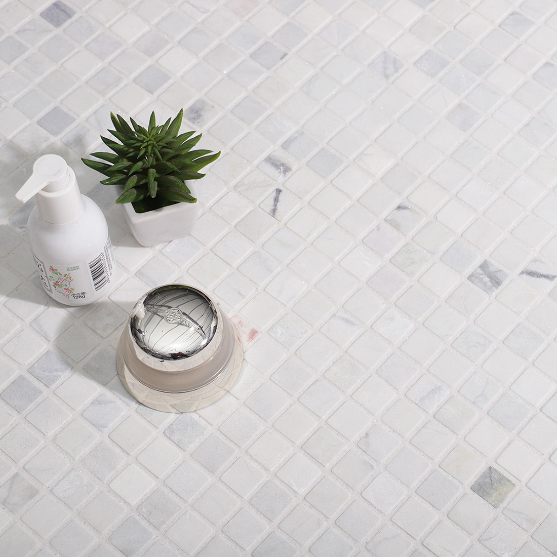 White marble square mosaic tile floor scene with minimalist bathroom accessories