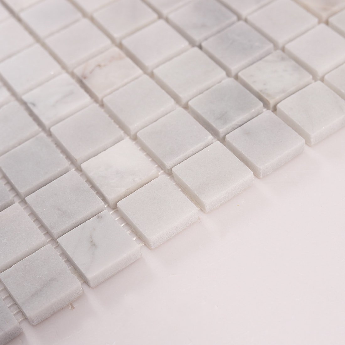 Side angle view showing thickness of white marble mosaic tiles