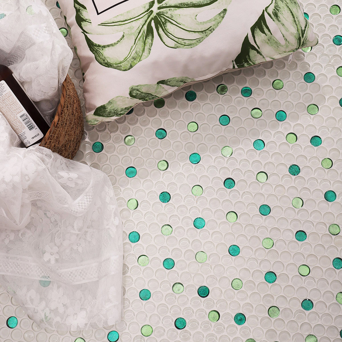 Decorative scene of penny round glass mosaic tile floor with green foil accents