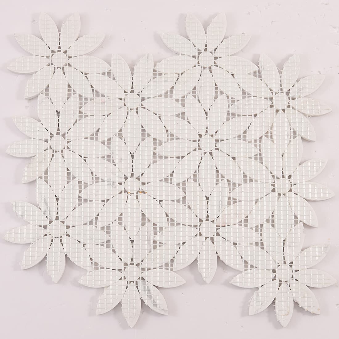 Back view of white petal flower marble mosaic sheet with mesh backing