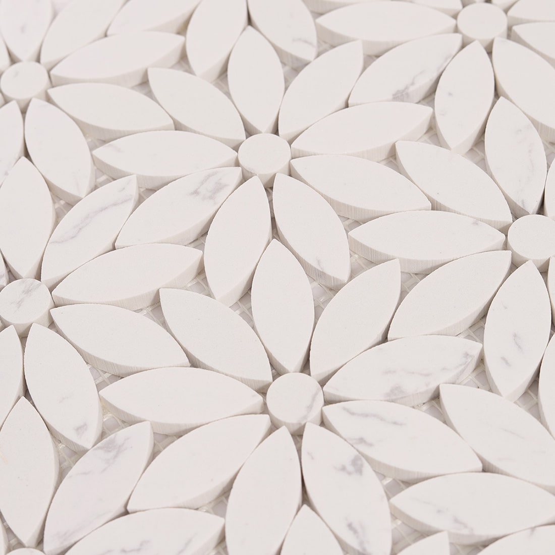 Close up of repeating white petal flower pattern marble mosaic