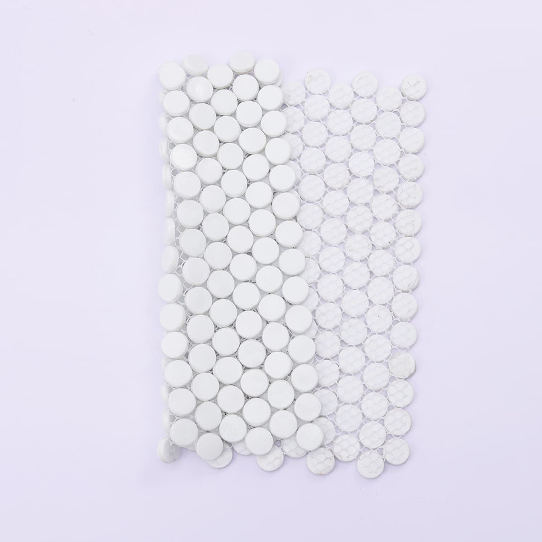 Back view of white round penny tile mosaic sheet showing mesh backing
