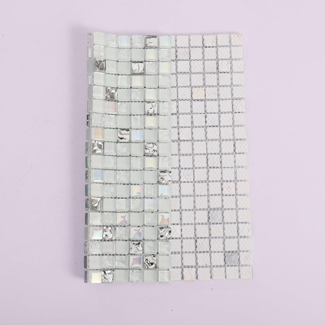 White and silver square glass mosaic sheet folded to show mesh backing