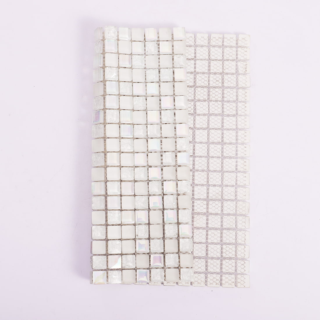 White square glass mosaic tile sheet folded to show mesh backing and front surface
