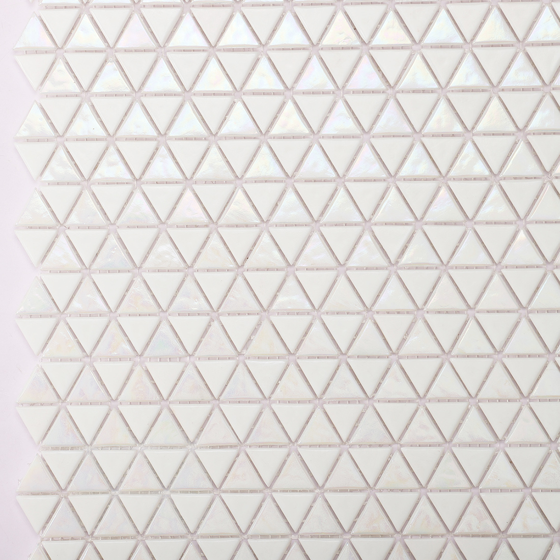 Close up of white triangle glass mosaic tiles with iridescent finish
