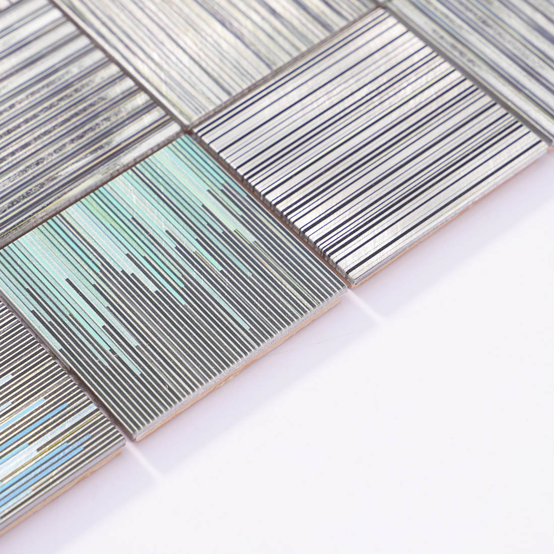 Angle shot of abstract barcode square aluminum mosaic tile showing edge