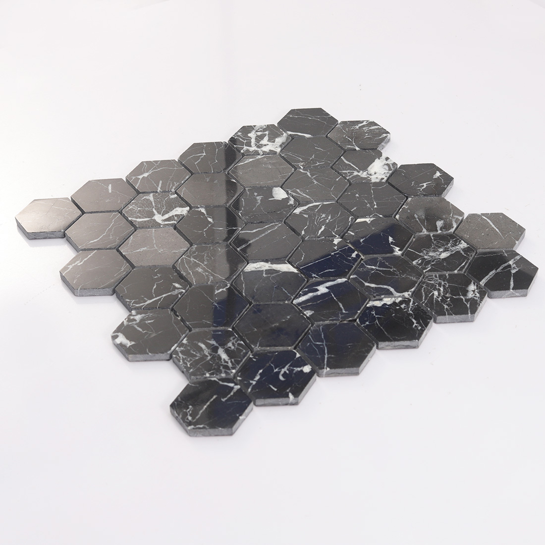 Angled black hexagon marble mosaic tile sheet with mixed dark stone tones