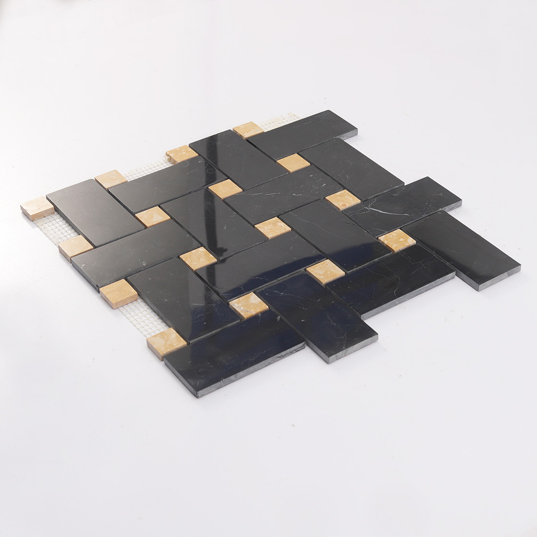 Angled black marble basketweave mosaic tile sheet with yellow marble dots