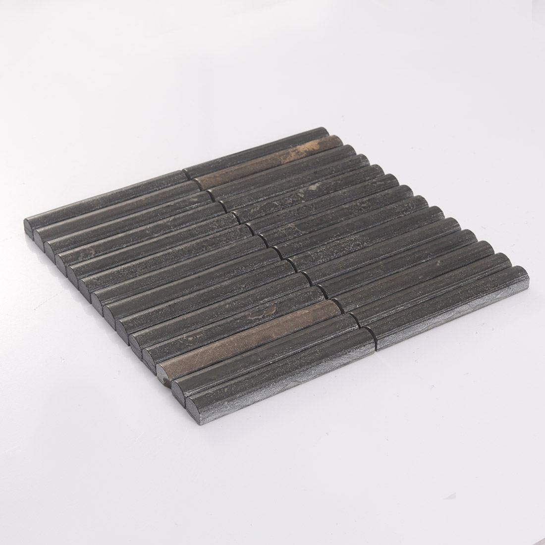 Angled chocolate brown natural stone mosaic sheet with slim rounded strips