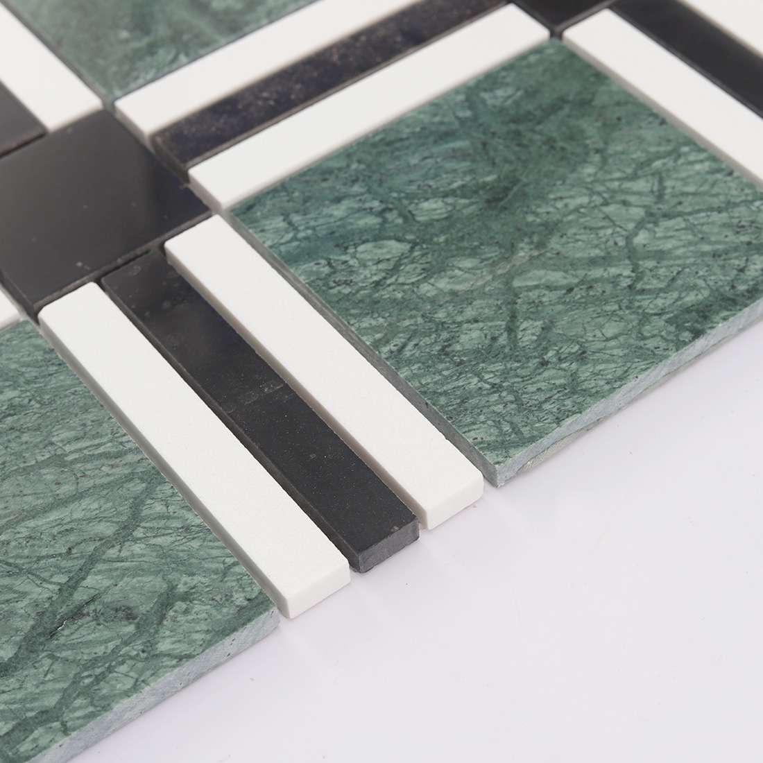 Angled edge view of green plaid marble mosaic tile with raised stone pieces