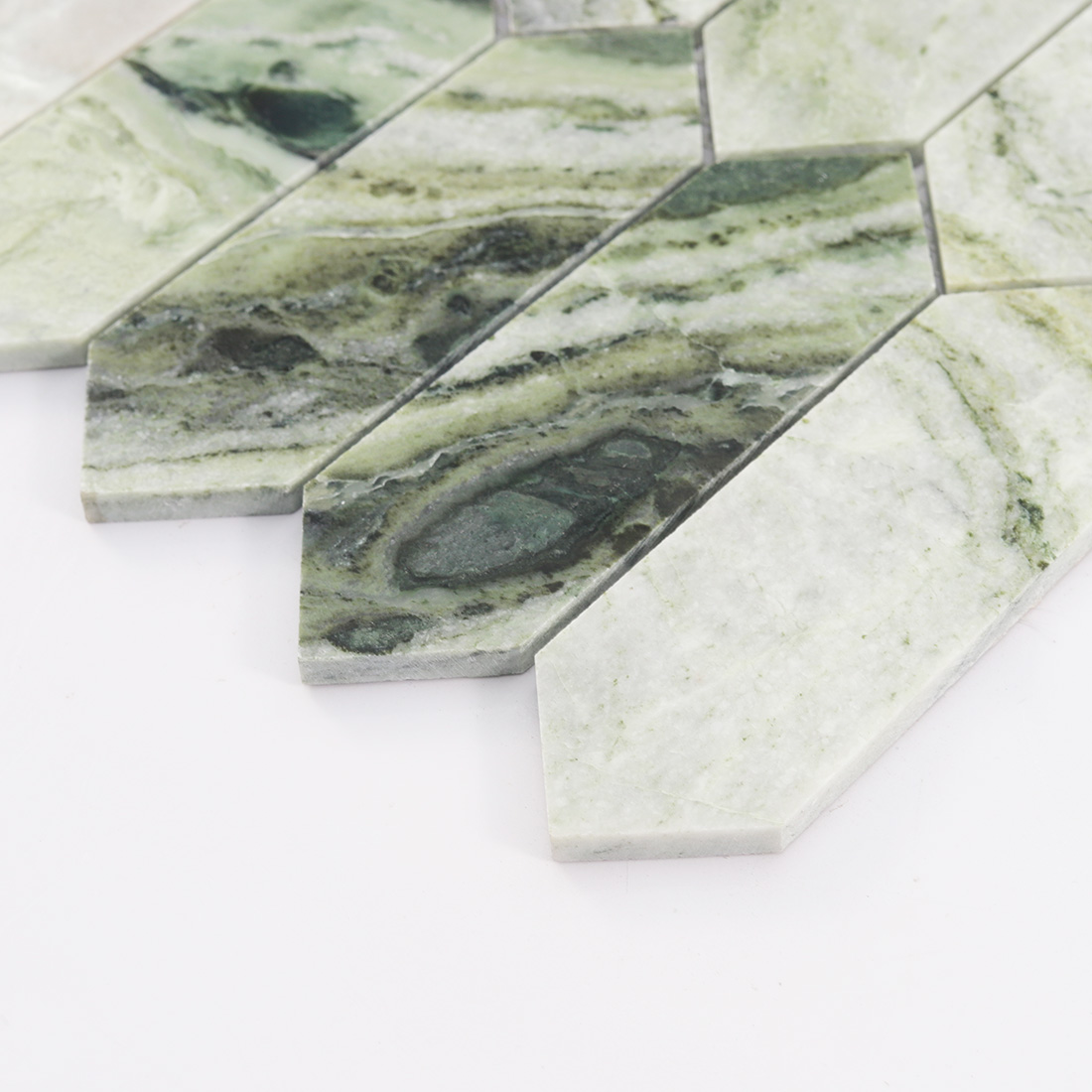 Angled edge view of light green picket marble tile with pointed ends