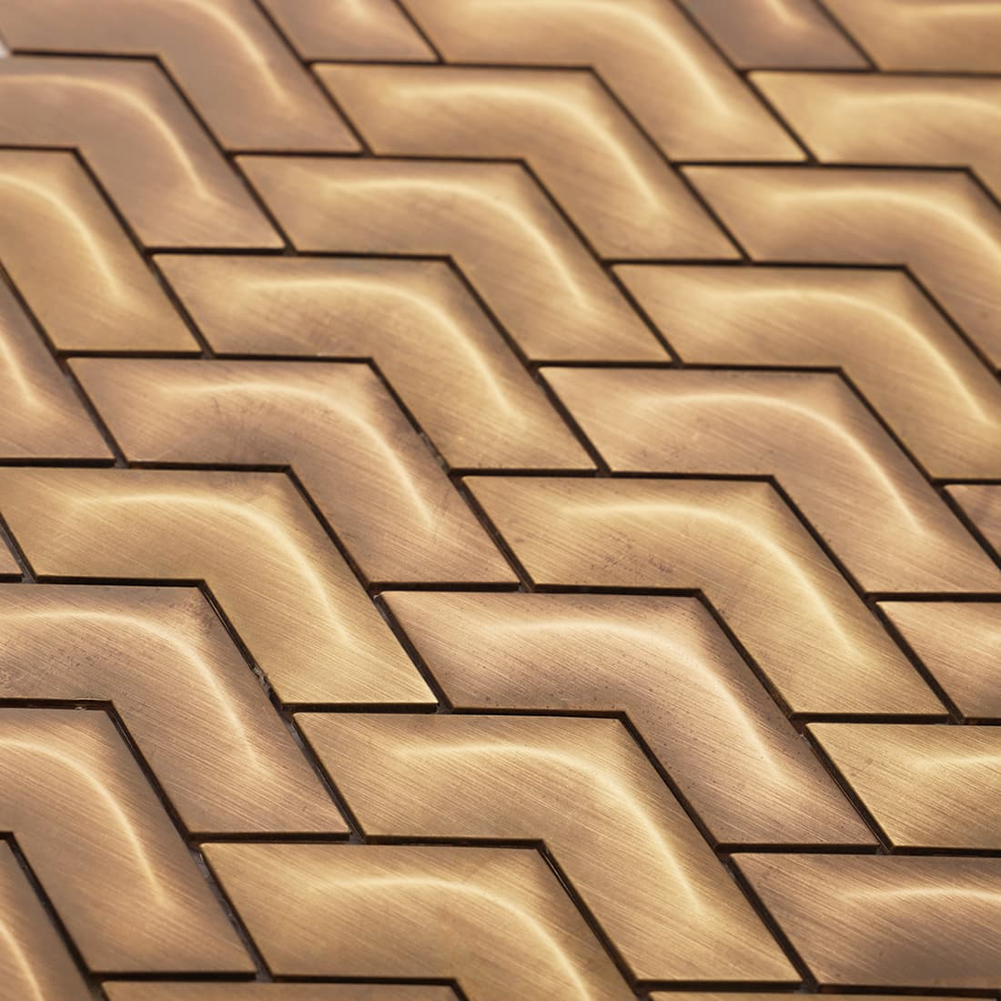 Close-up of antique brass chevron metal mosaic tile pattern