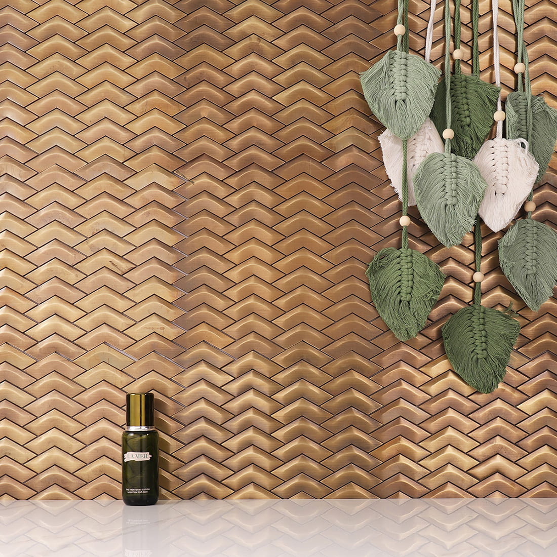 Antique brass chevron metal mosaic tile wall with bottle and leaf decor