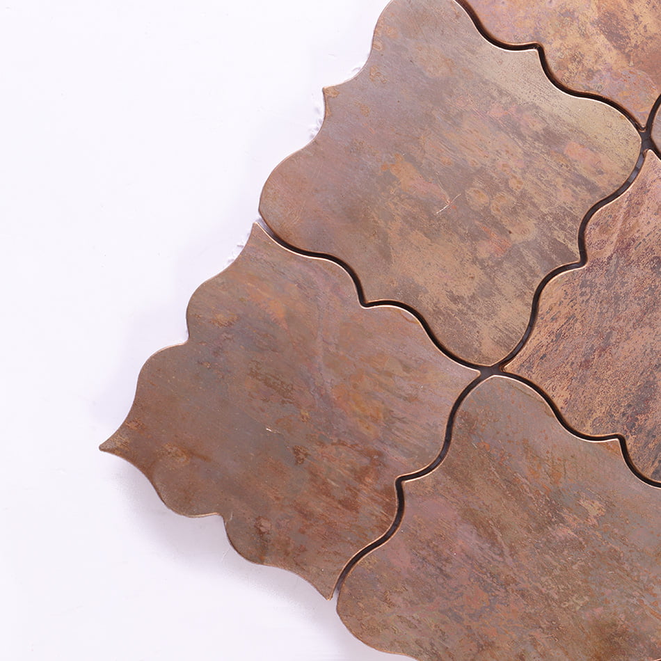 Corner detail of antique copper arabesque metal mosaic tile