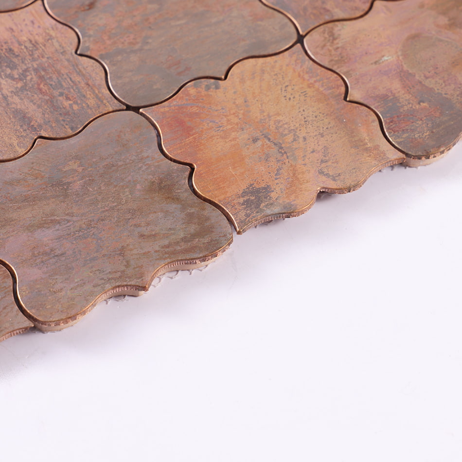 Edge detail of antique copper arabesque metal mosaic tile