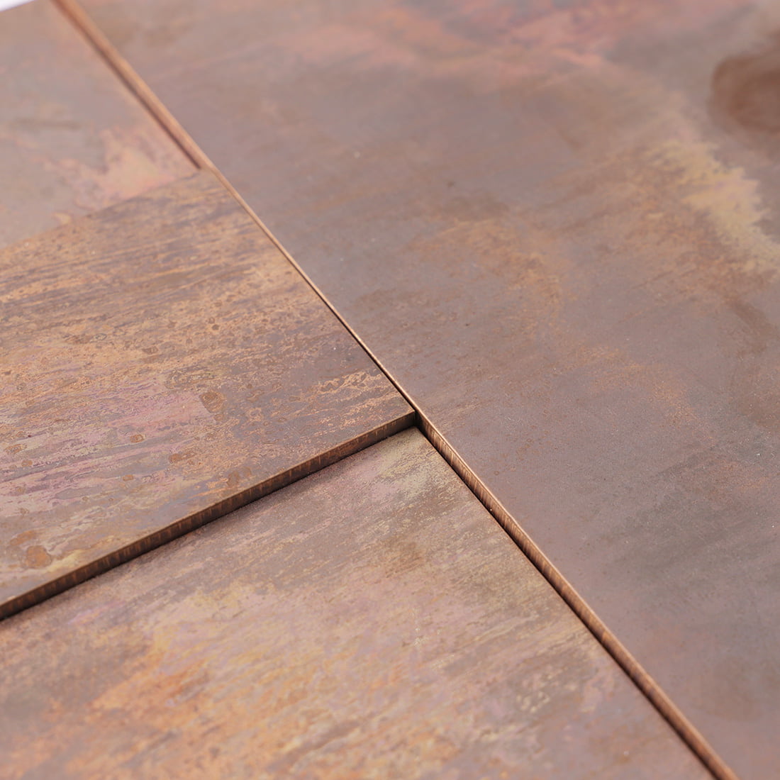 Close-up of antique copper mixed rectangle metal mosaic tile surface