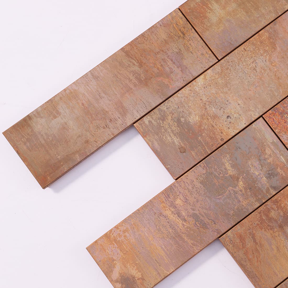 Corner detail of antique copper rectangular metal mosaic tile