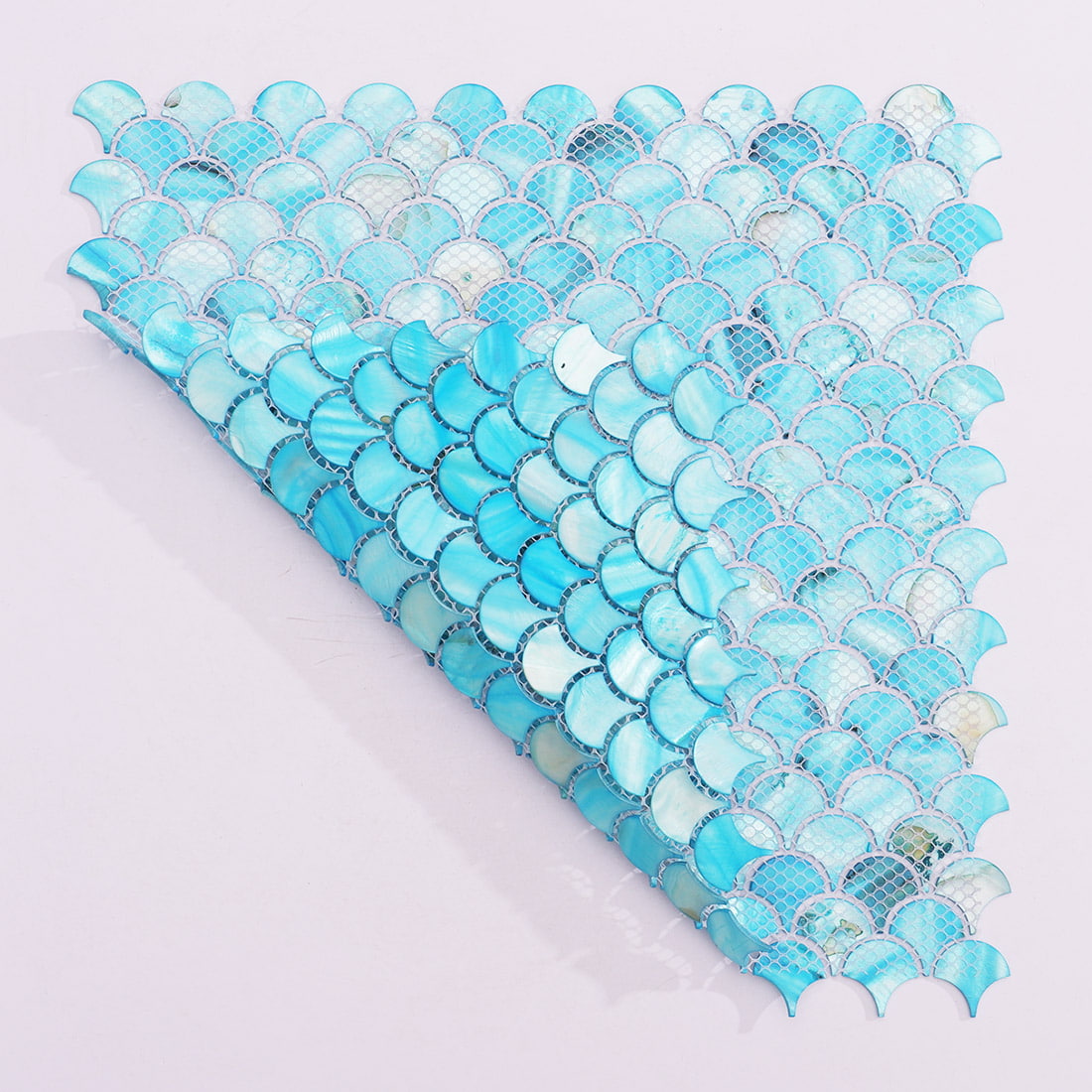 Folded aqua blue mother of pearl fan mosaic tile sheet showing mesh backing