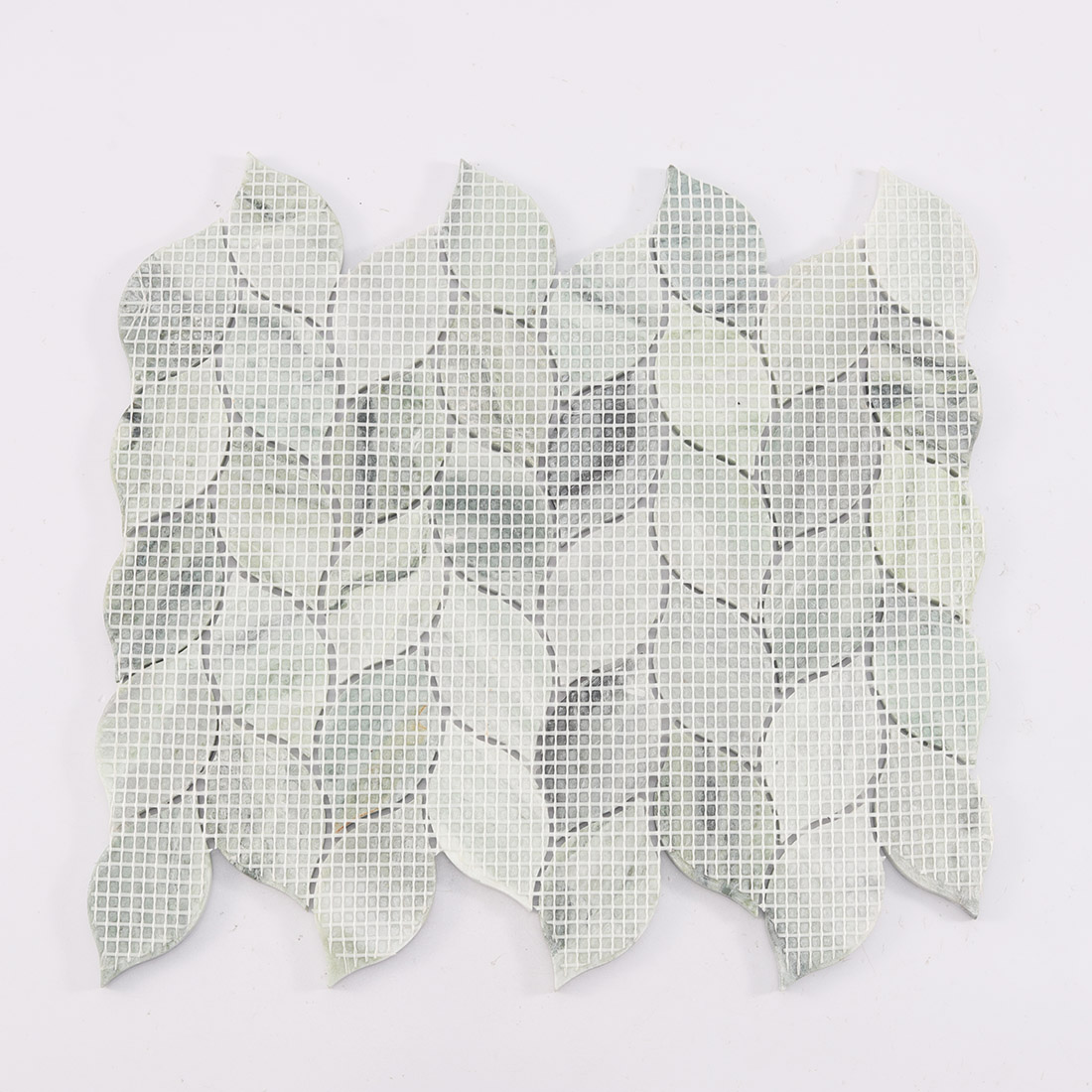 Mesh backing on the reverse side of marble leaf mosaic.
