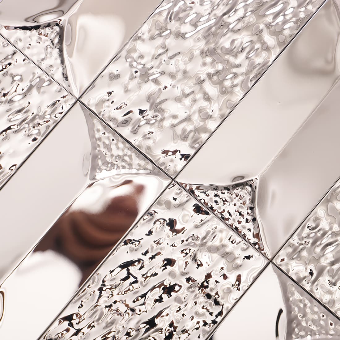 Angled profile view highlighting smooth and textured silver stainless steel tile.