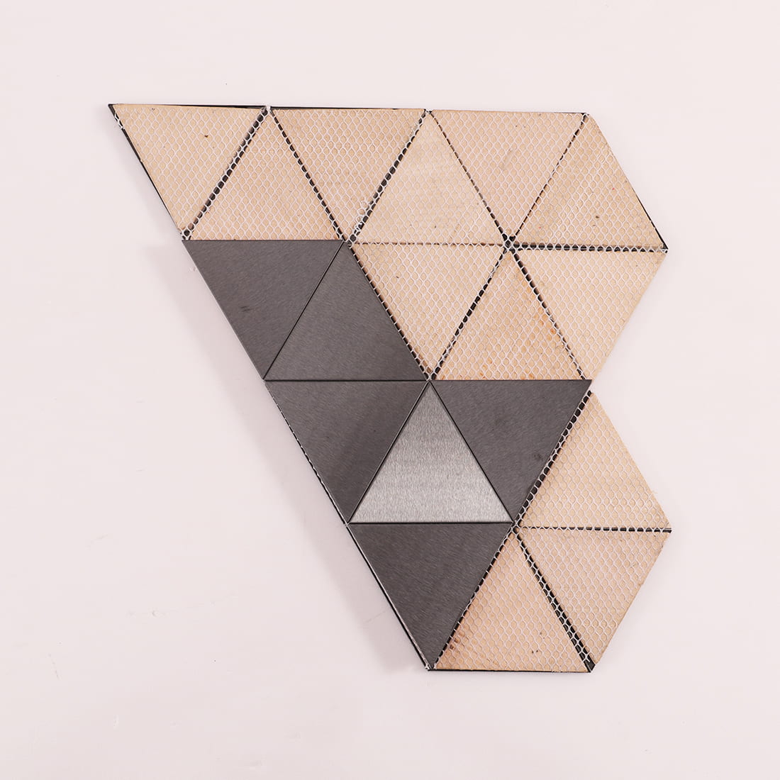 Back view showing the mesh mounting and adhesive on triangular metal tiles.