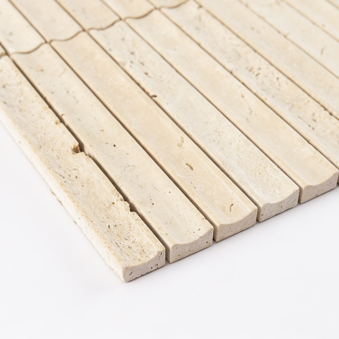 Close-up showing the curved profile of fluted travertine.