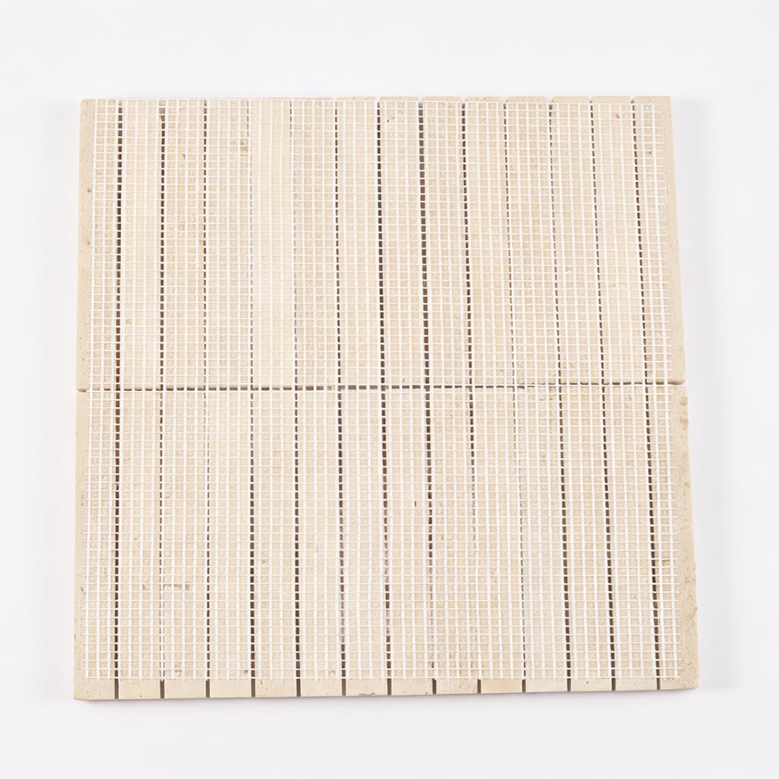 Mesh backing on the reverse side of fluted travertine tile.