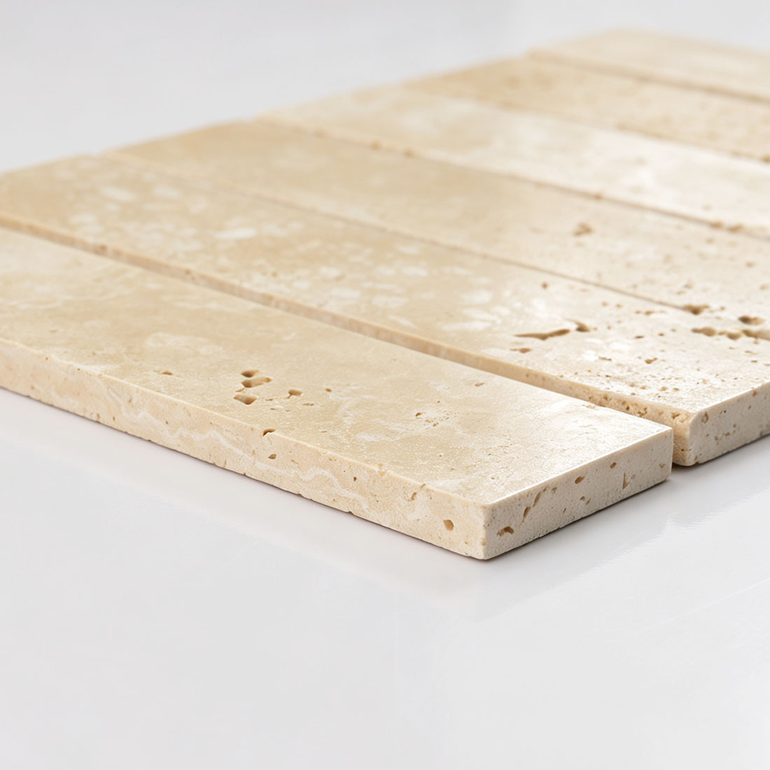 Macro view of beige linear travertine mosaic tile edge and surface