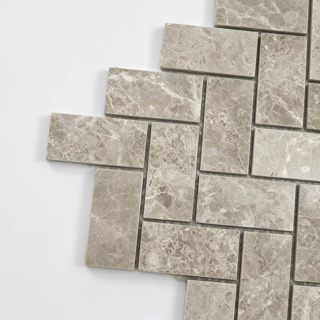 Close-up of beige marble herringbone mosaic tile pattern