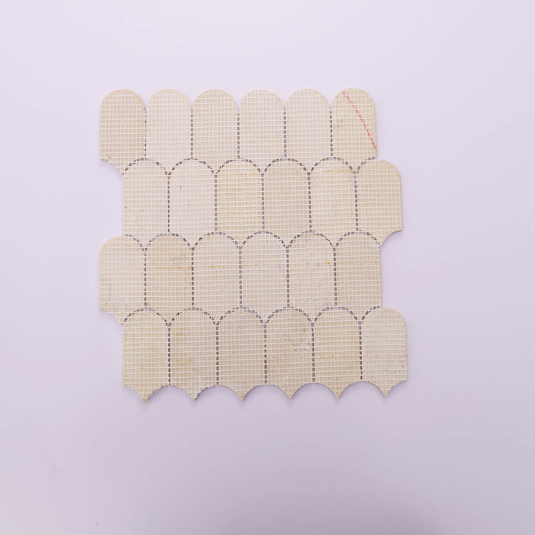 Sturdy mesh backing on the reverse side of beige marble mosaic tile