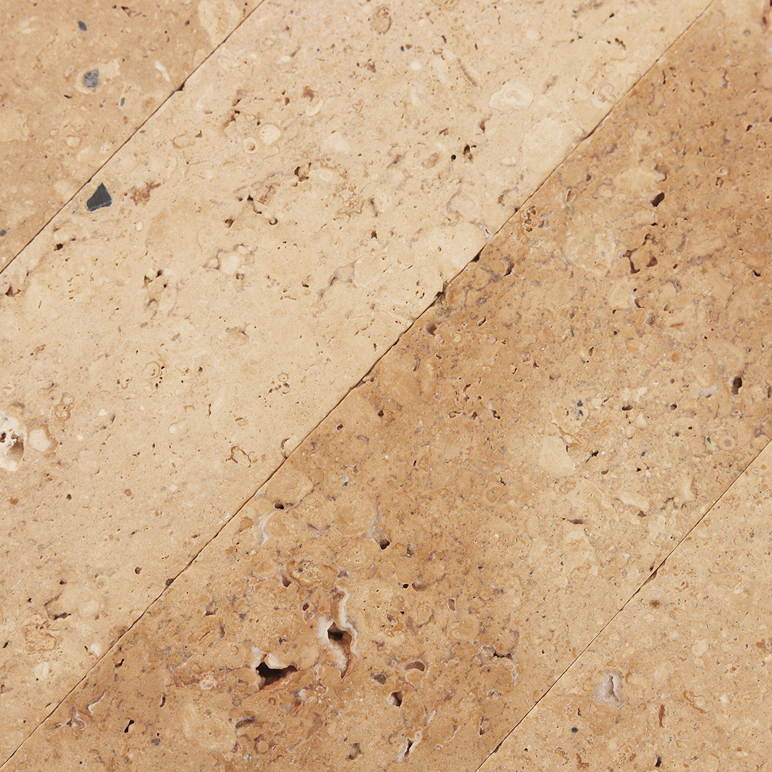 Edge detail of beige marble tile highlighting thickness and smooth finish