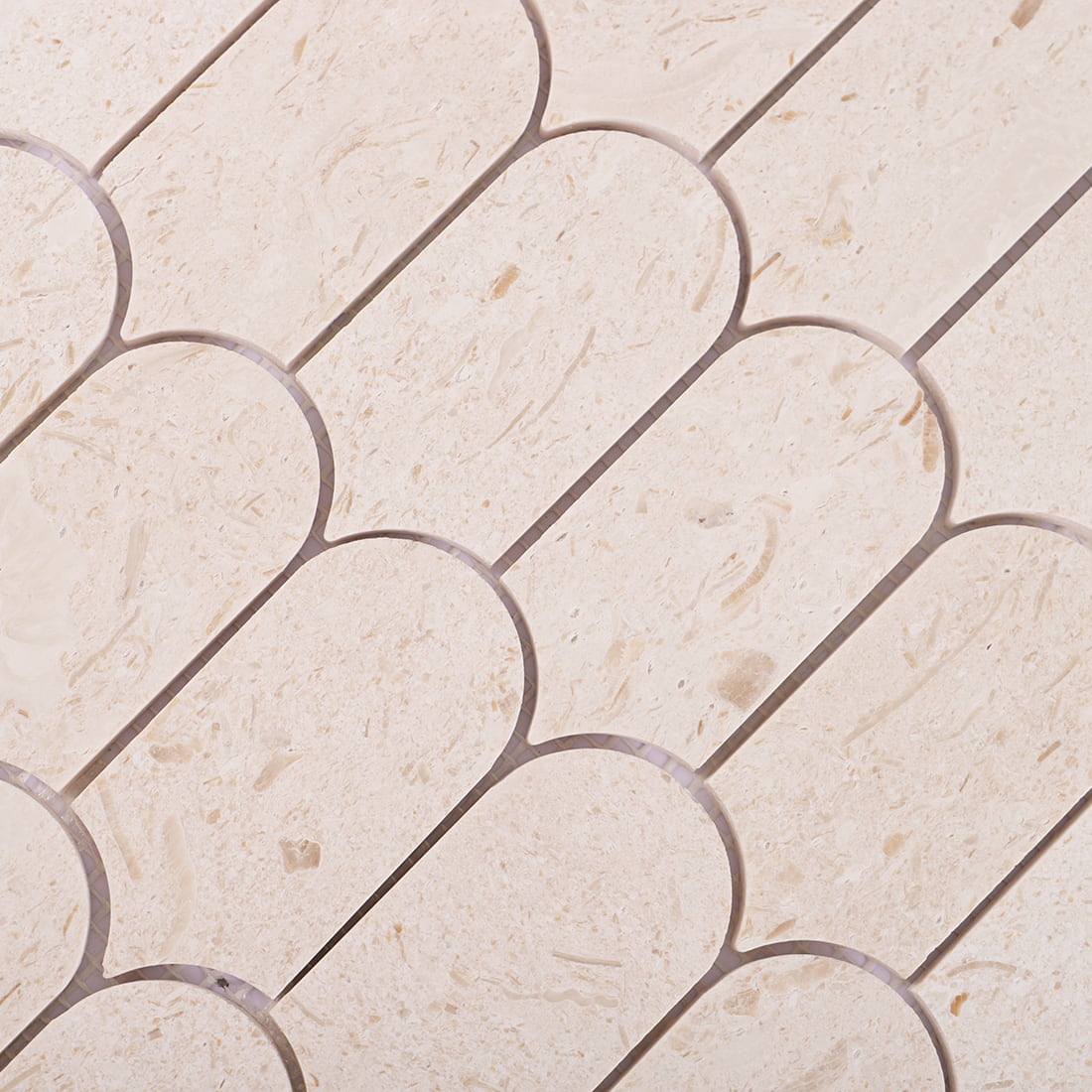 Close-up of beige marble scallop mosaic tile pattern