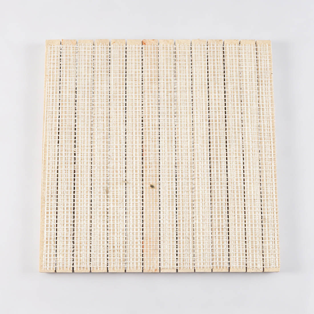 Mesh backing view of beige travertine convex liner tile sheet