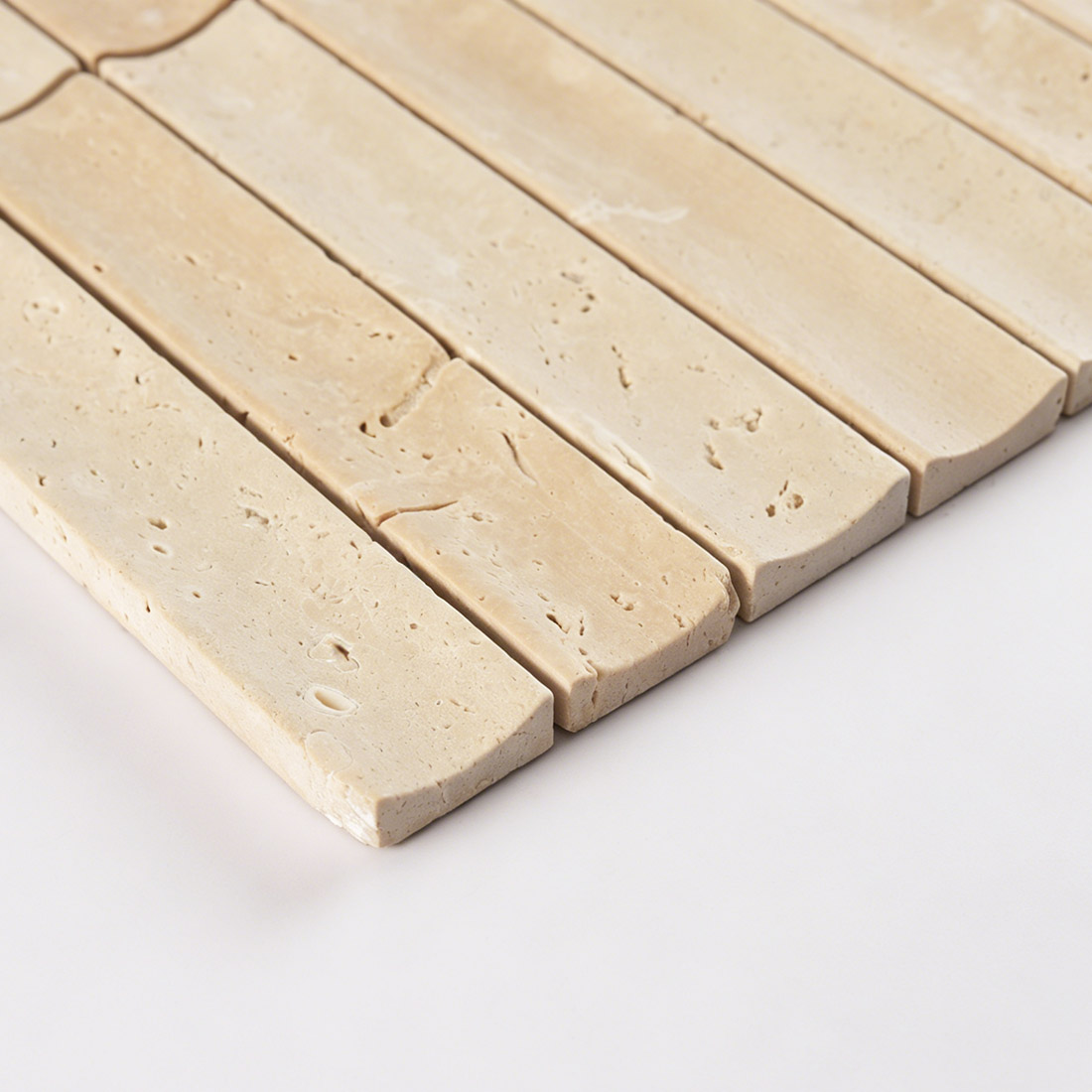 Edge profile of fluted beige travertine linear tile.