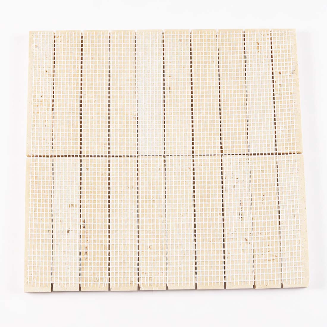 Mesh backing on beige travertine fluted linear tile.