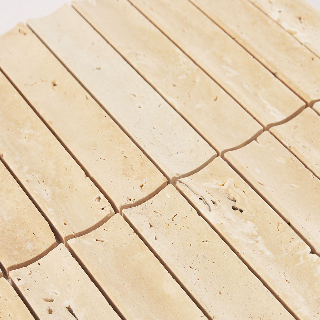 Surface texture and natural pits of beige fluted travertine.