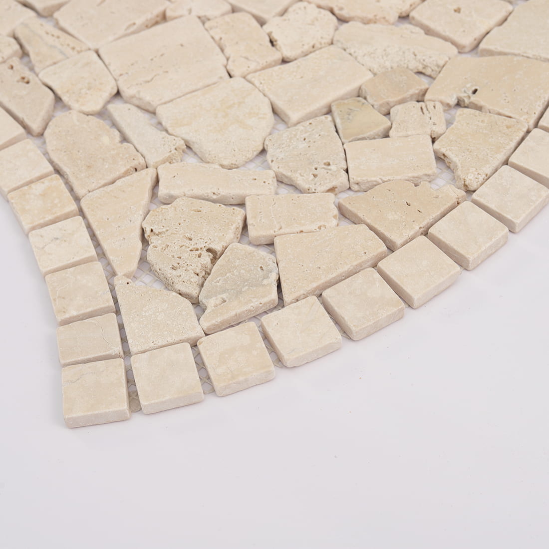 Detail of beige travertine irregular mosaic with curved square border