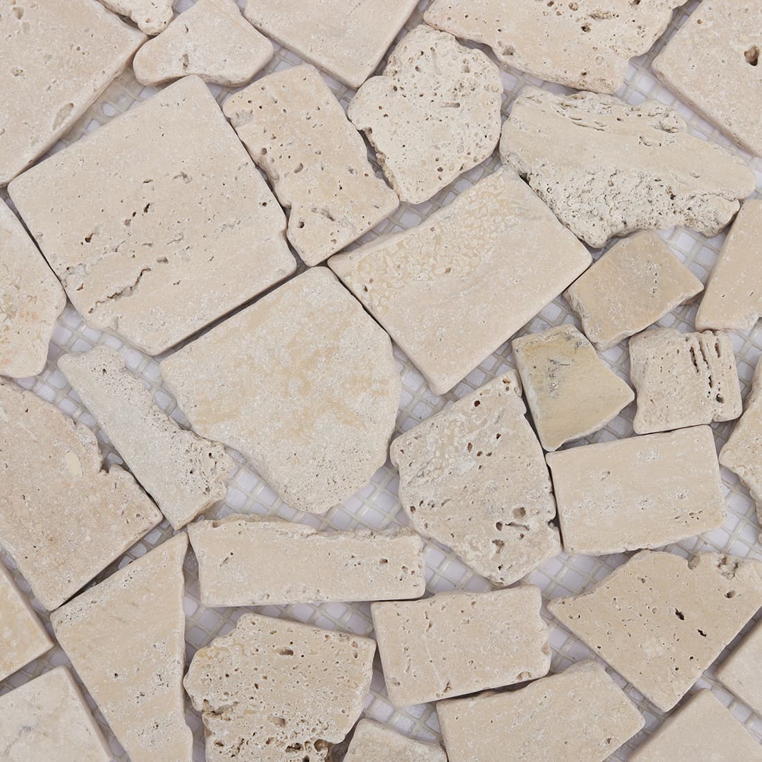 Close up of beige travertine irregular mosaic pieces with natural texture