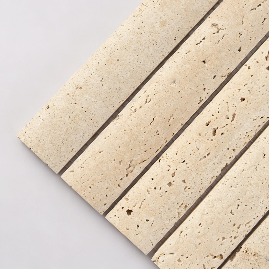 Close up of beige travertine linear stone tile with porous texture