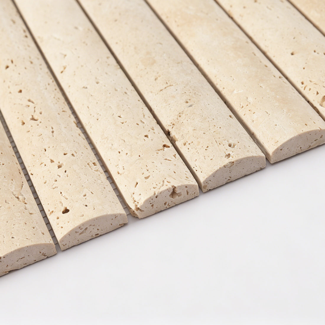 Edge profile of beige travertine long bar tile showing soft rounded edge
