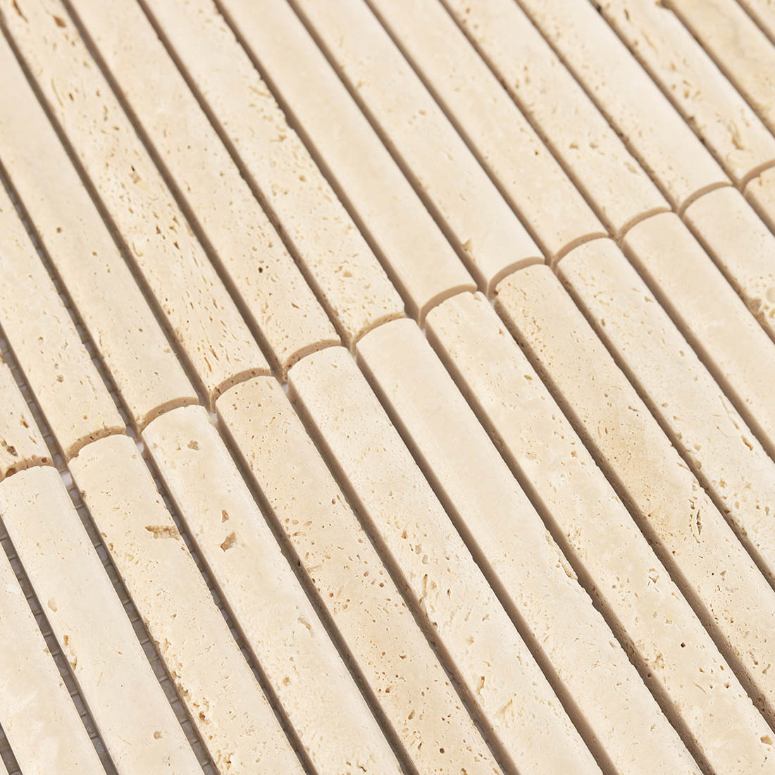 Detailed surface texture and natural pitted pattern of beige travertine.