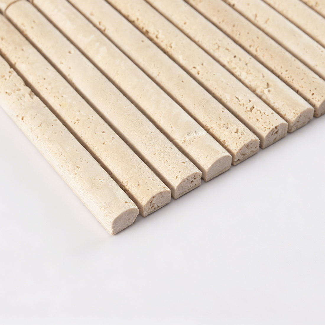 Side profile view highlighting the semi-circle rod contour of beige travertine.