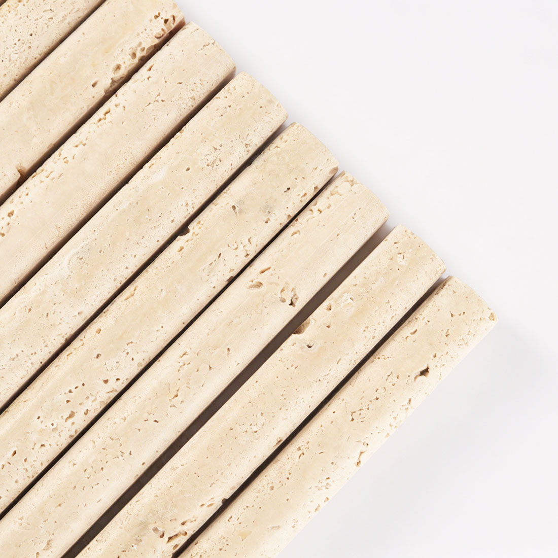 Close up of beige travertine rounded liner tile with natural holes