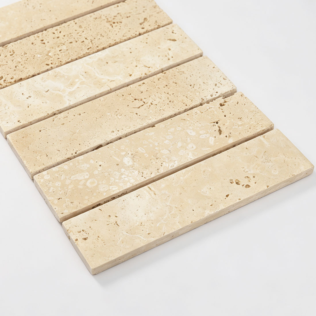 Close-up texture of beige travertine strip tile with natural pores